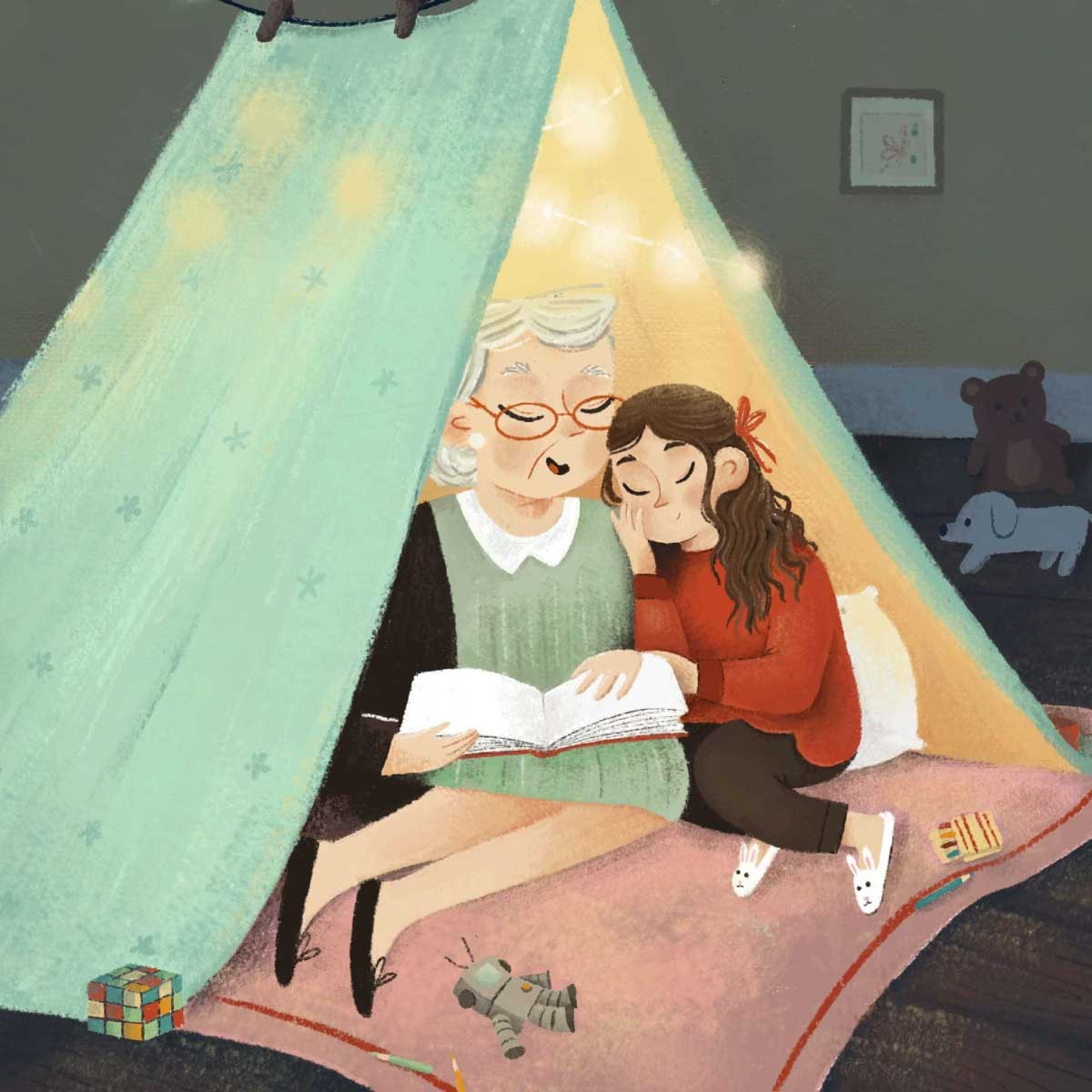 An illustration of an older woman with gray hair reading a book to a young girl with long, curly hair who is leaning against her shoulder, both sitting inside a teal and yellow blanket fort with string lights.